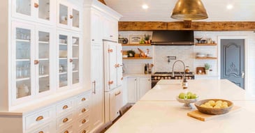 Kitchen remodel with white cabinetry, rose gold hardware, and white stone countertops by Cabinet Creations in Clarkston, Michigan