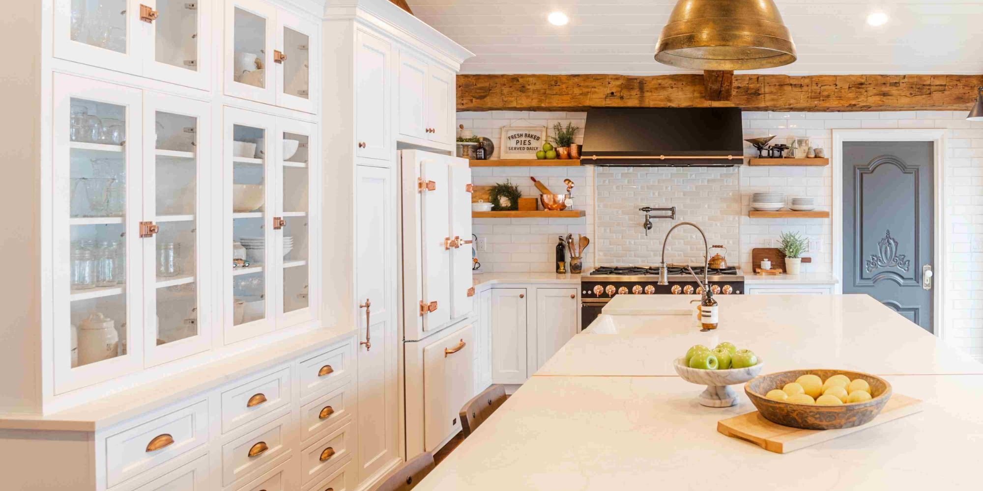 Kitchen remodel with white cabinetry, rose gold hardware, and white stone countertops by Cabinet Creations in Clarkston, Michigan