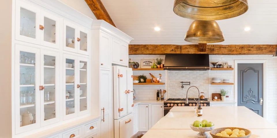 Custom kitchen remodel in Oakland County MI by Cabinet Creations with glass cabinets and rustic wood beams