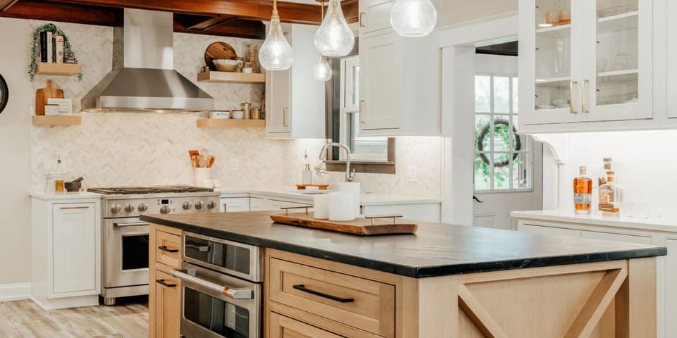 Oakland County kitchen remodel with stainless steel range hood, pendant lighting, and a double oven island