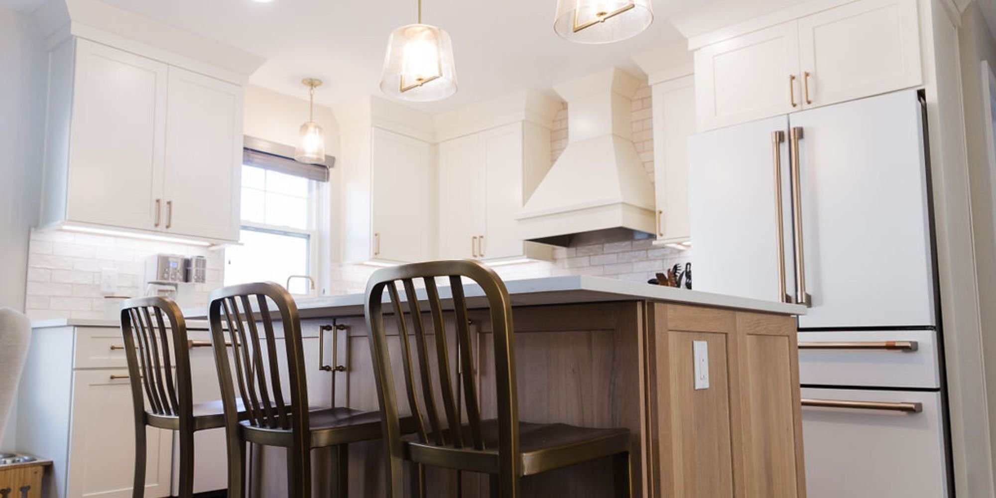 Cabinet Creations kitchen remodel in Waterford, MI with brass accents, wood island, and clean white cabinetry