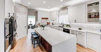 Updated kitchen in Oakland County with two-tone island and subway tile backsplash by Cabinet Creations