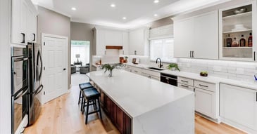 Updated kitchen in Oakland County with two-tone island and subway tile backsplash by Cabinet Creations