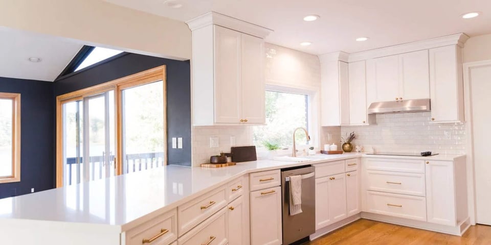 Bright kitchen renovation in Oakland County featuring quartz counters and brass accents by Cabinet Creations