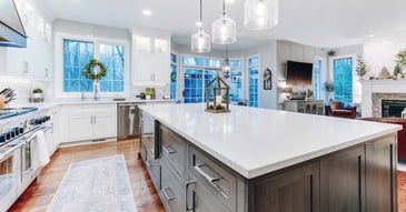 Bright custom kitchen remodel with white cabinets and large island by Cabinet Creations in Oakland County, MI