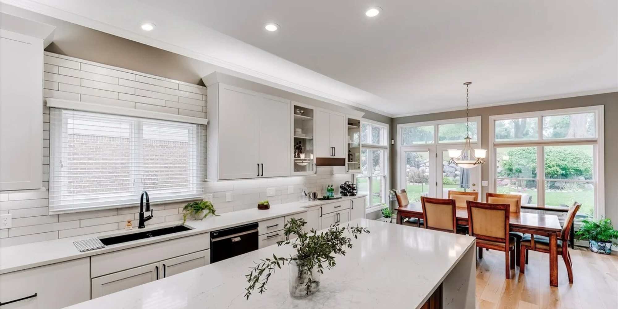 Transitional kitchen design with white shaker cabinets and large island by Cabinet Creations in Oakland County, MI