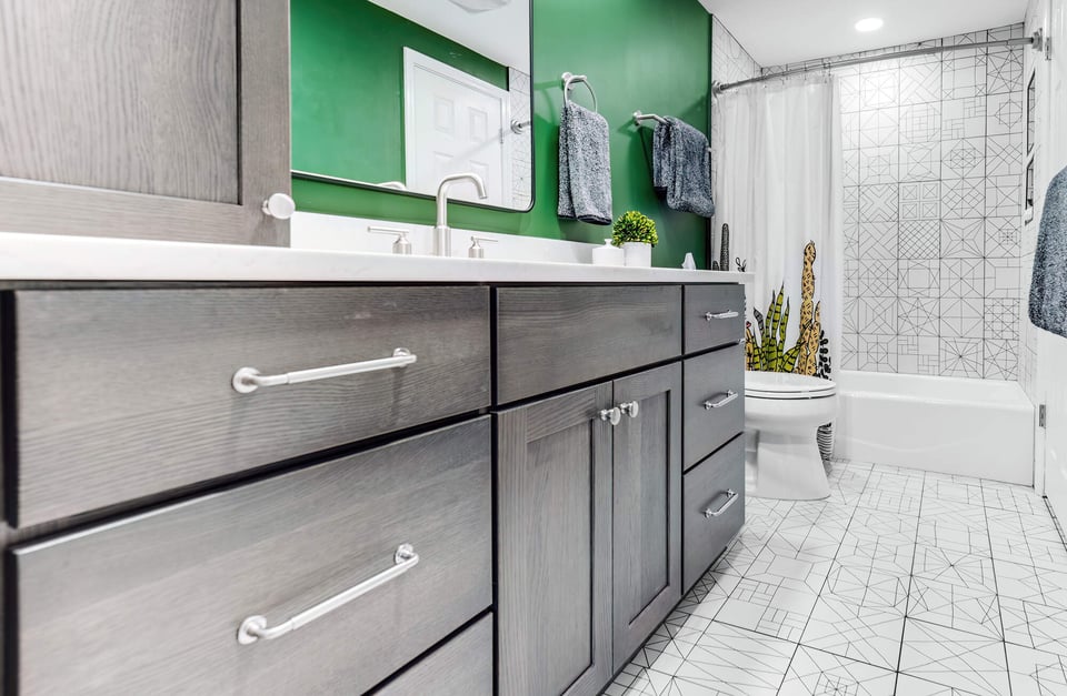 Modern custom bathroom remodel by Cabinet Creations in Oakland County, MI featuring gray cabinetry and geometric tile design