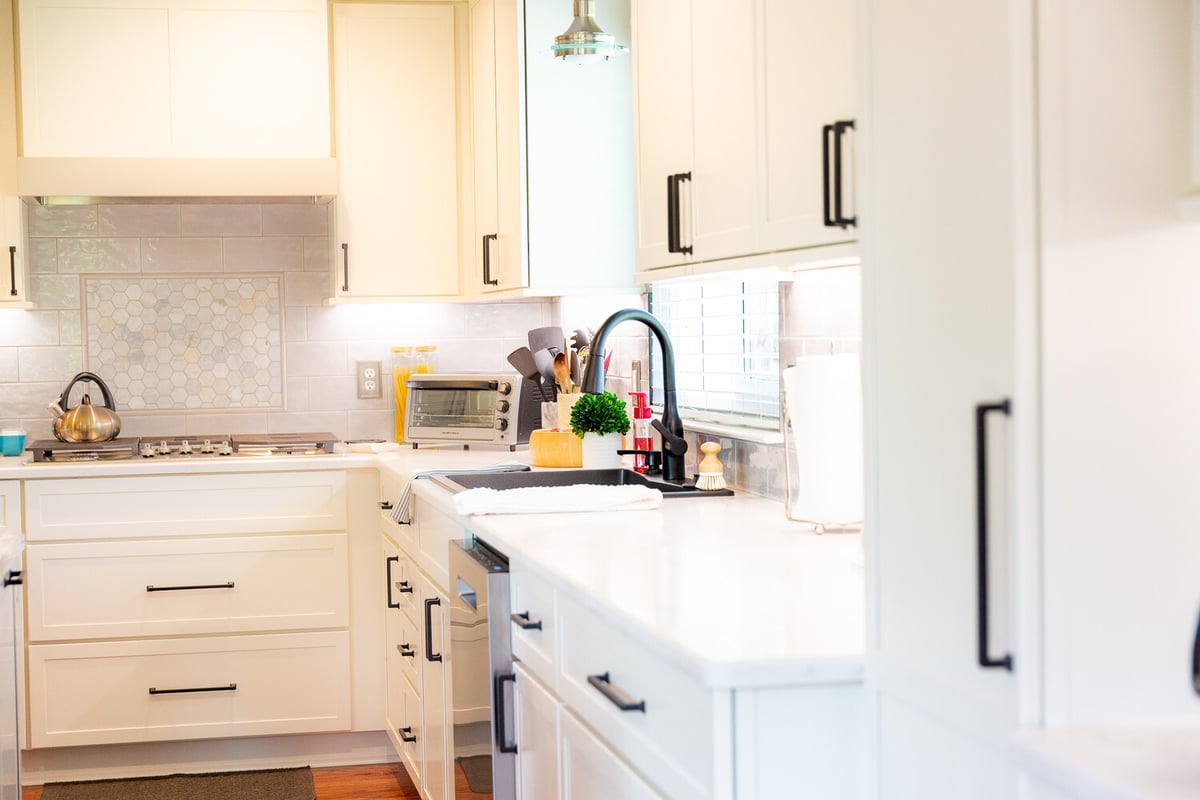 Bright custom kitchen remodel with white shaker cabinets and modern backsplash by Cabinet Creations in White Lake, Michigan