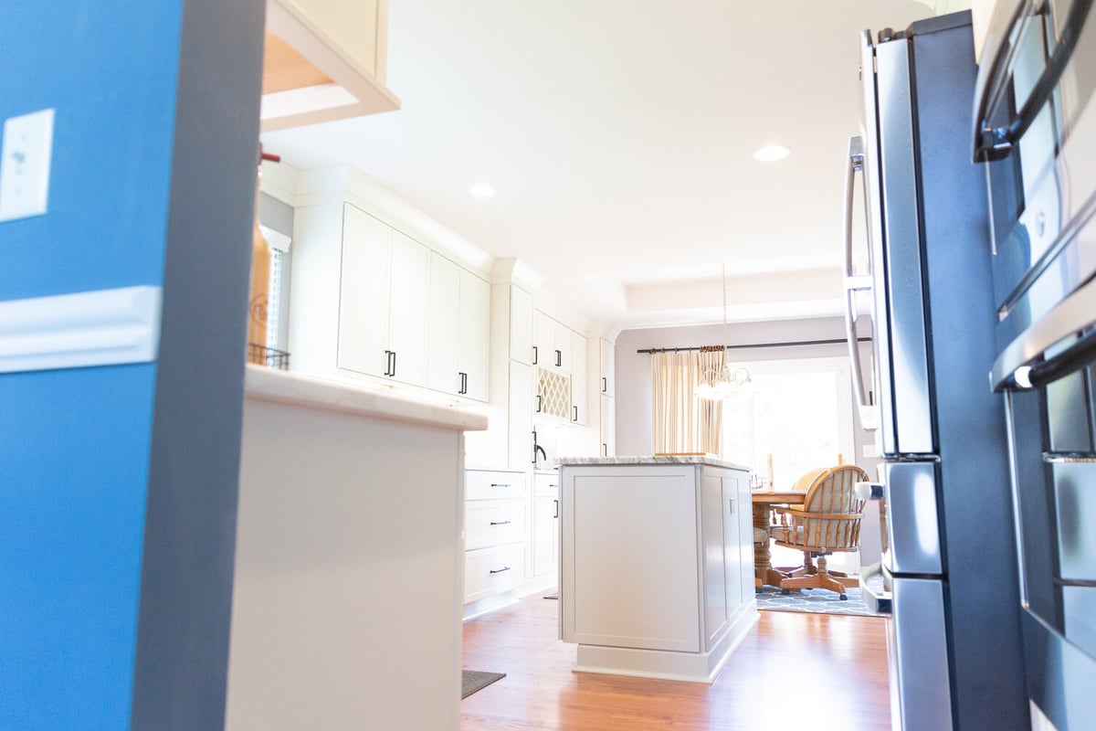 Bright open-concept kitchen with island and dining area by Cabinet Creations in Oakland County, MI