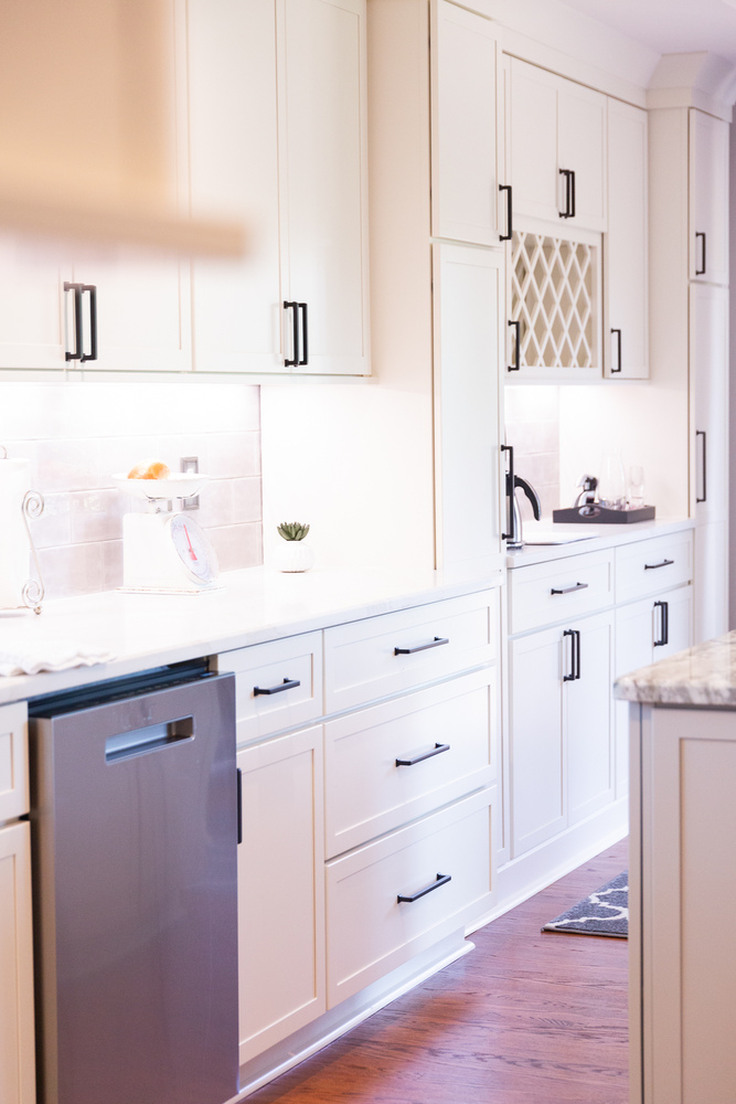Contemporary kitchen remodel with white cabinets and marble countertops by Cabinet Creations in White Lake, Michigan