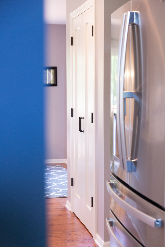 Custom home kitchen entryway with double pantry doors by Cabinet Creations in Oxford, Michigan