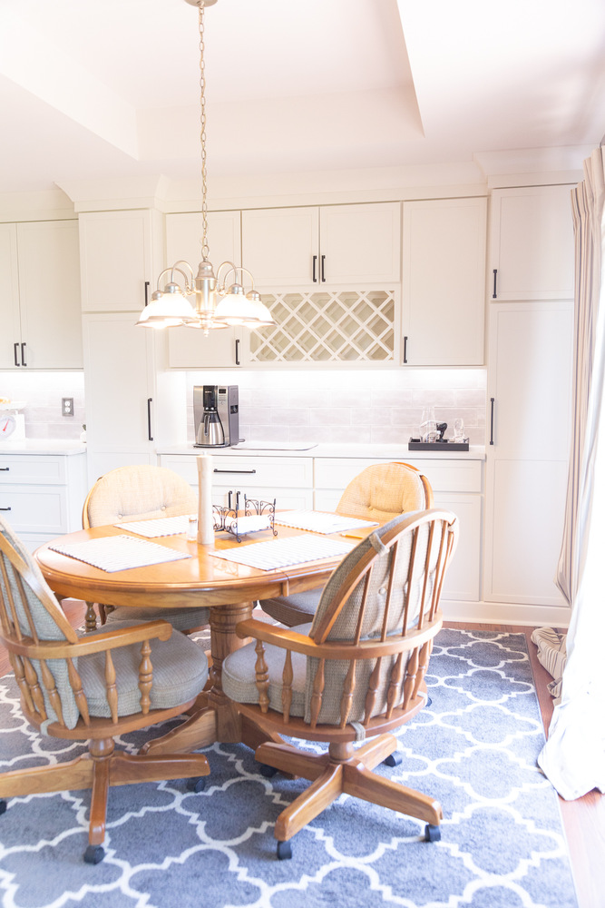 Custom kitchen and dining space with chandelier and white cabinetry by Cabinet Creations in Troy, MI