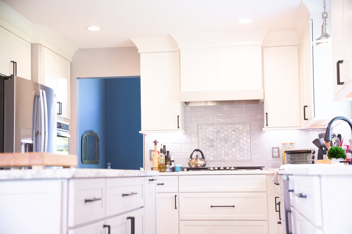 Custom kitchen remodel featuring marble backsplash and range area by Cabinet Creations in Waterford Township, Michigan