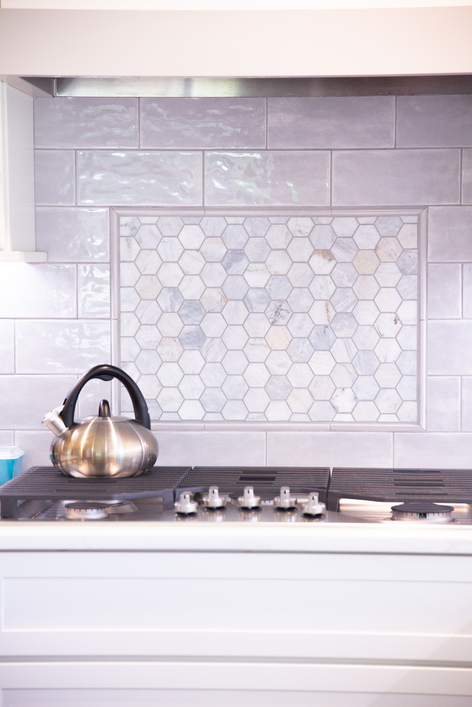Custom kitchen remodel with stainless kettle and hex tile backsplash by Cabinet Creations in White Lake, Michigan