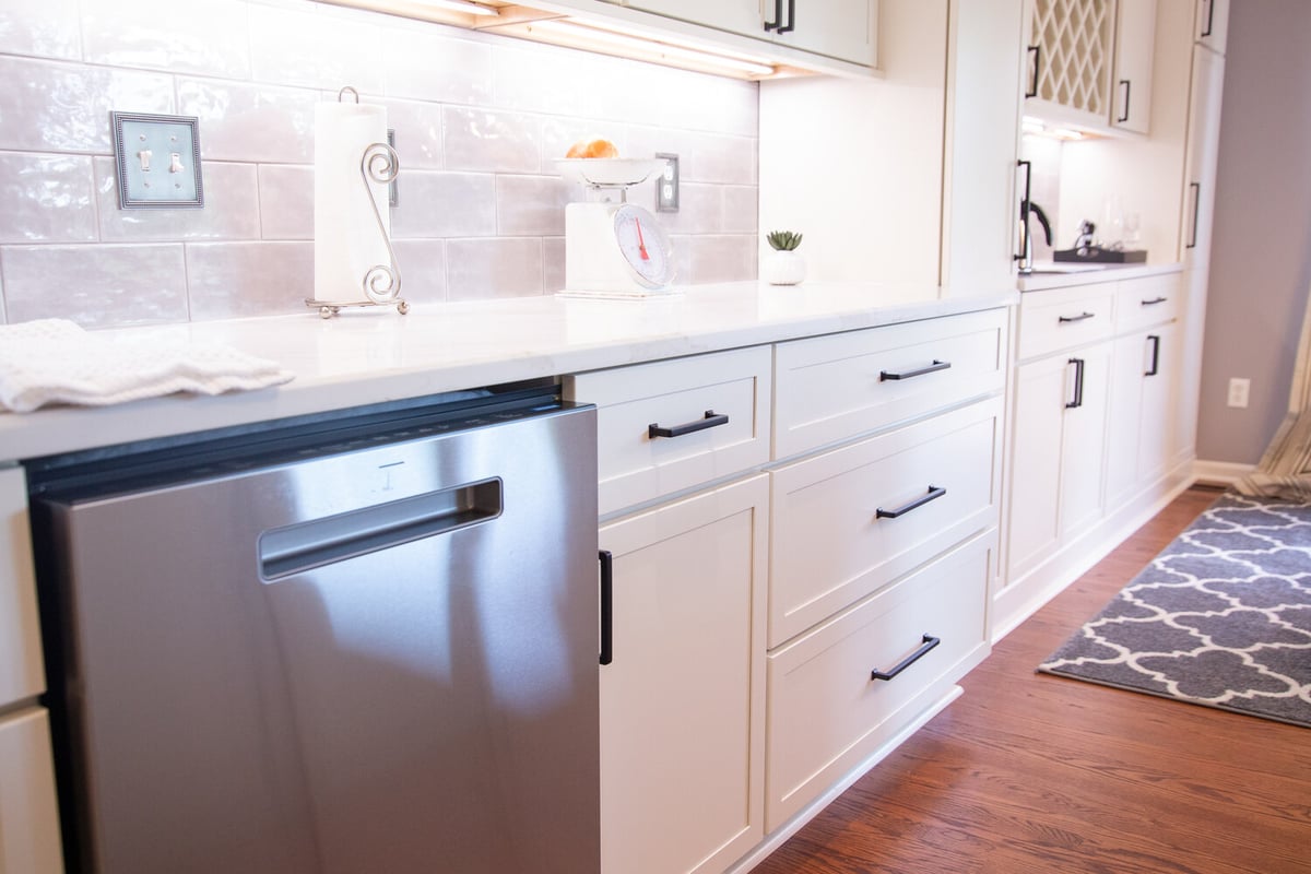 Custom kitchen remodel with white cabinets and stainless steel dishwasher by Cabinet Creations in Birmingham, Michigan