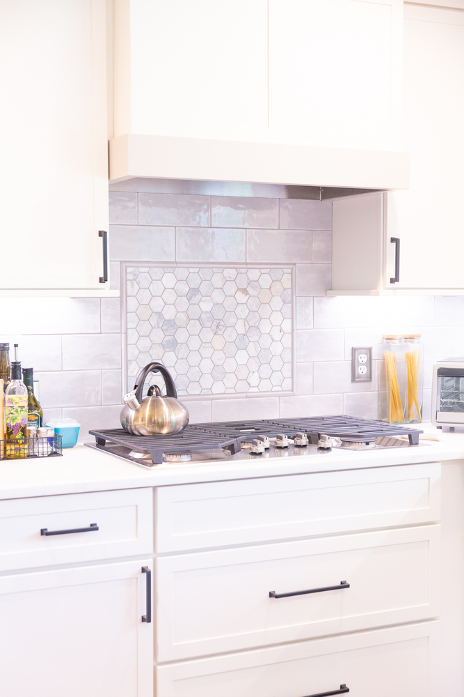 Elegant kitchen design featuring modern backsplash and stainless steel range by Cabinet Creations in Oakland County, MI