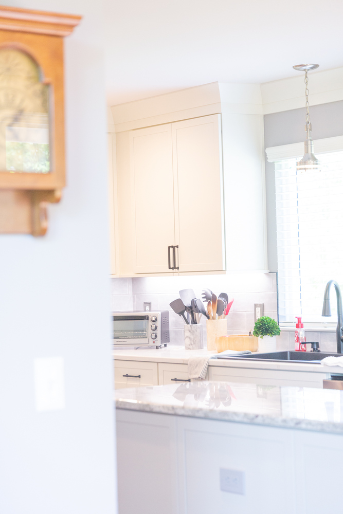 Elegant kitchen remodel with marble island and white cabinetry by Cabinet Creations in Waterford Township, Michigan