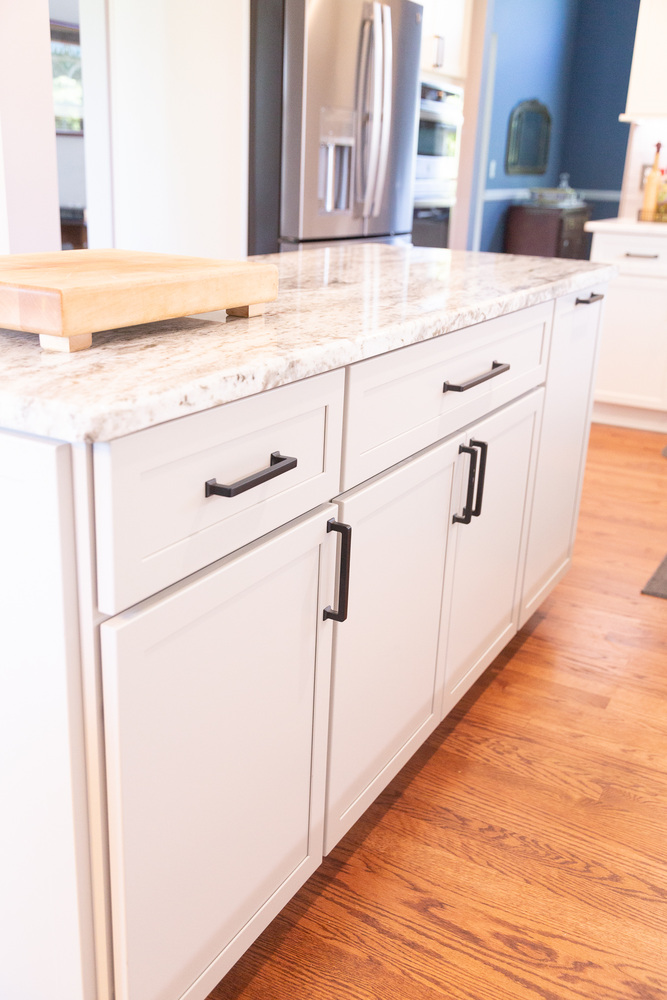 Elegant kitchen space featuring marble island and white shaker cabinets by Cabinet Creations in Oakland County, MI