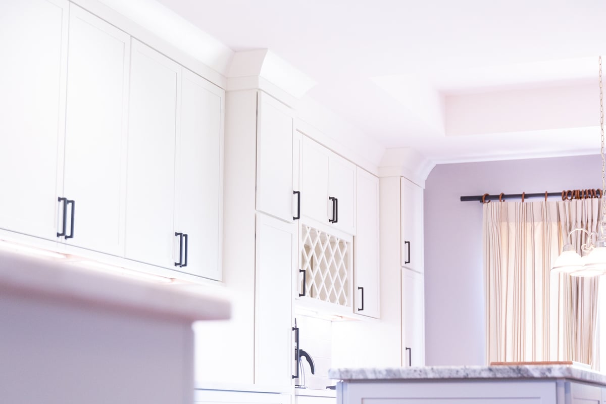 Elegant upper cabinetry and wine storage area by Cabinet Creations in Waterford Township, Michigan