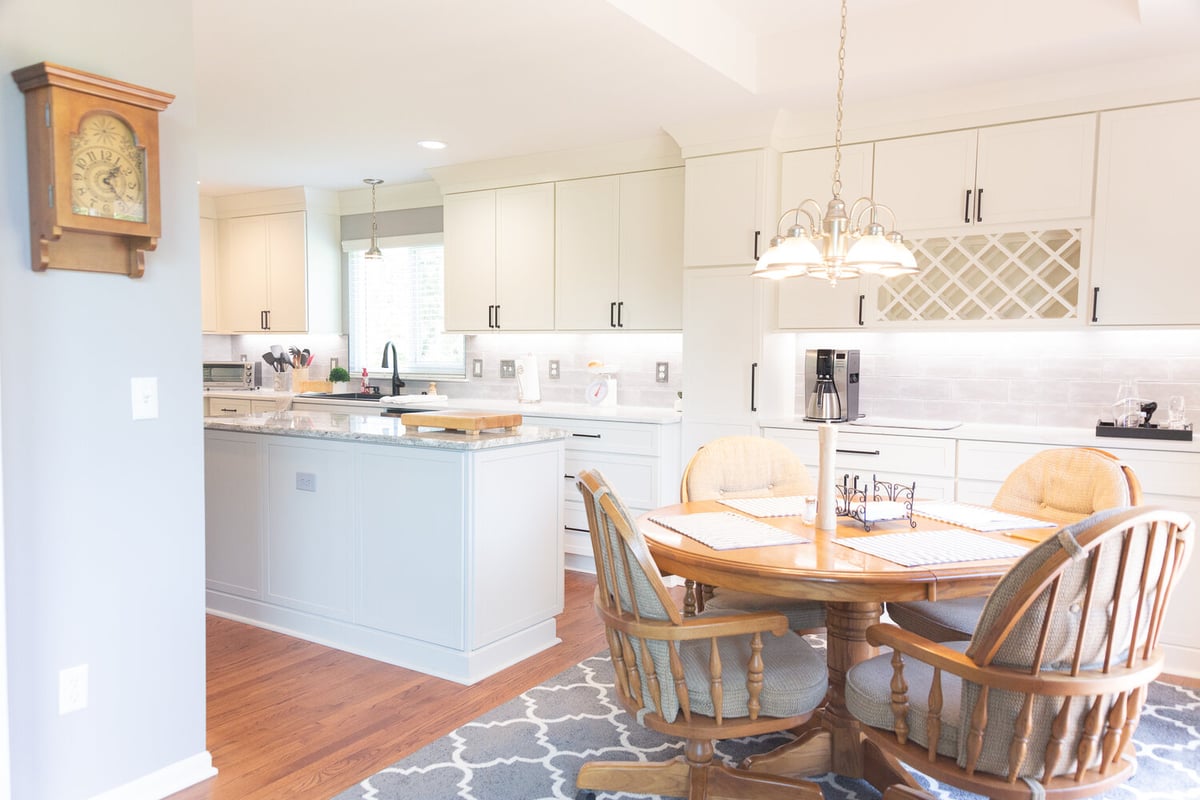 Kitchen island and dining area with natural light in a custom home by Cabinet Creations in Troy, Michigan
