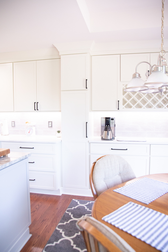 Modern custom kitchen remodel featuring stainless steel cooktop and tile backsplash by Cabinet Creations in White Lake, Michigan