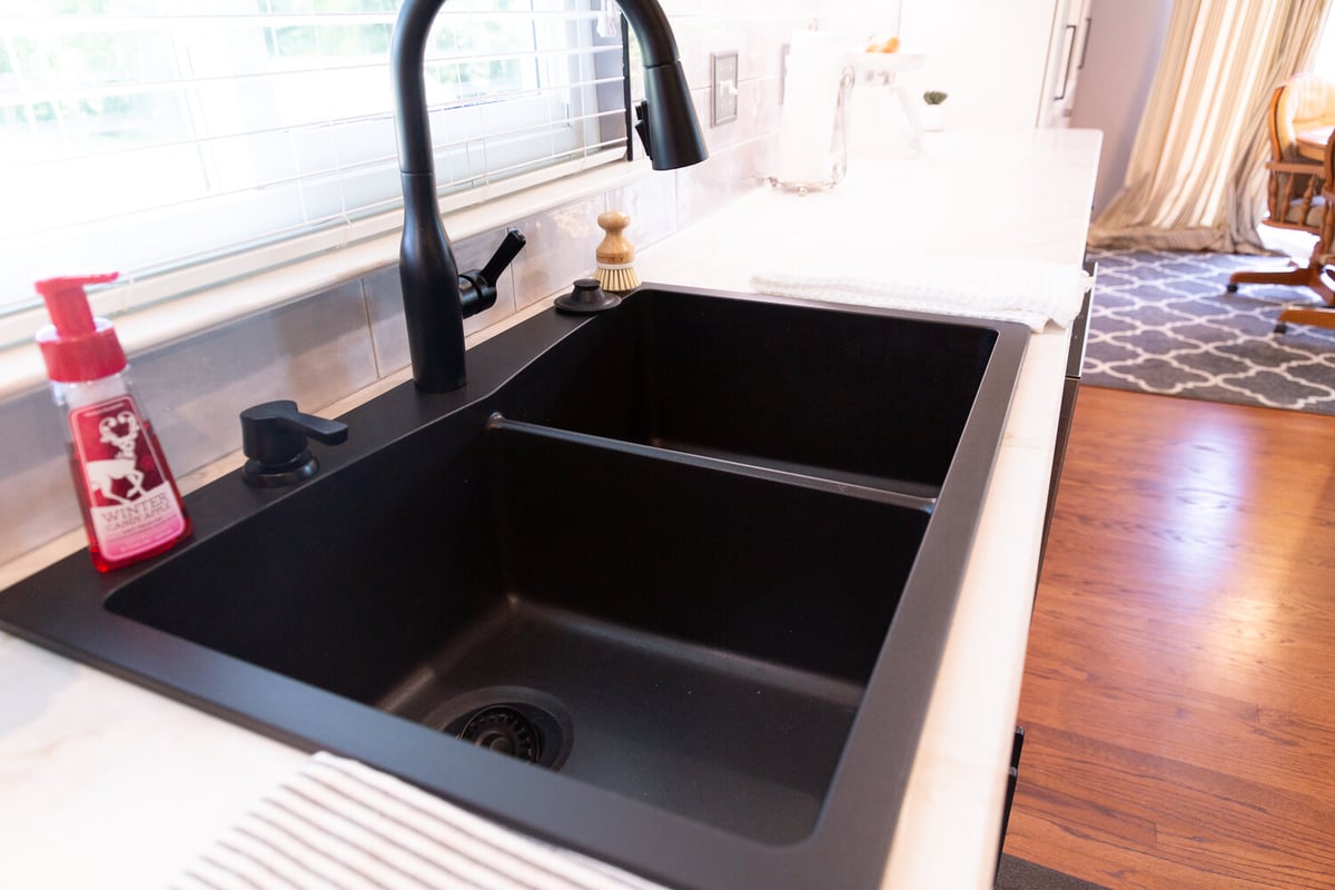 Modern dual-basin black sink in a bright custom kitchen by Cabinet Creations, Oakland County, MI