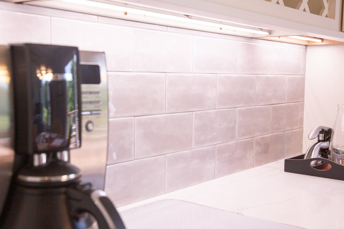 Modern kitchen backsplash with under-cabinet lighting by Cabinet Creations in Bloomfield Hills, MI