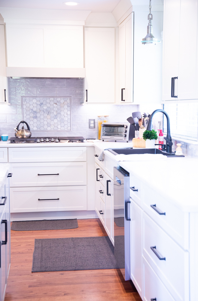 Open custom kitchen remodel with bright cabinetry and black fixtures by Cabinet Creations in White Lake, Michigan