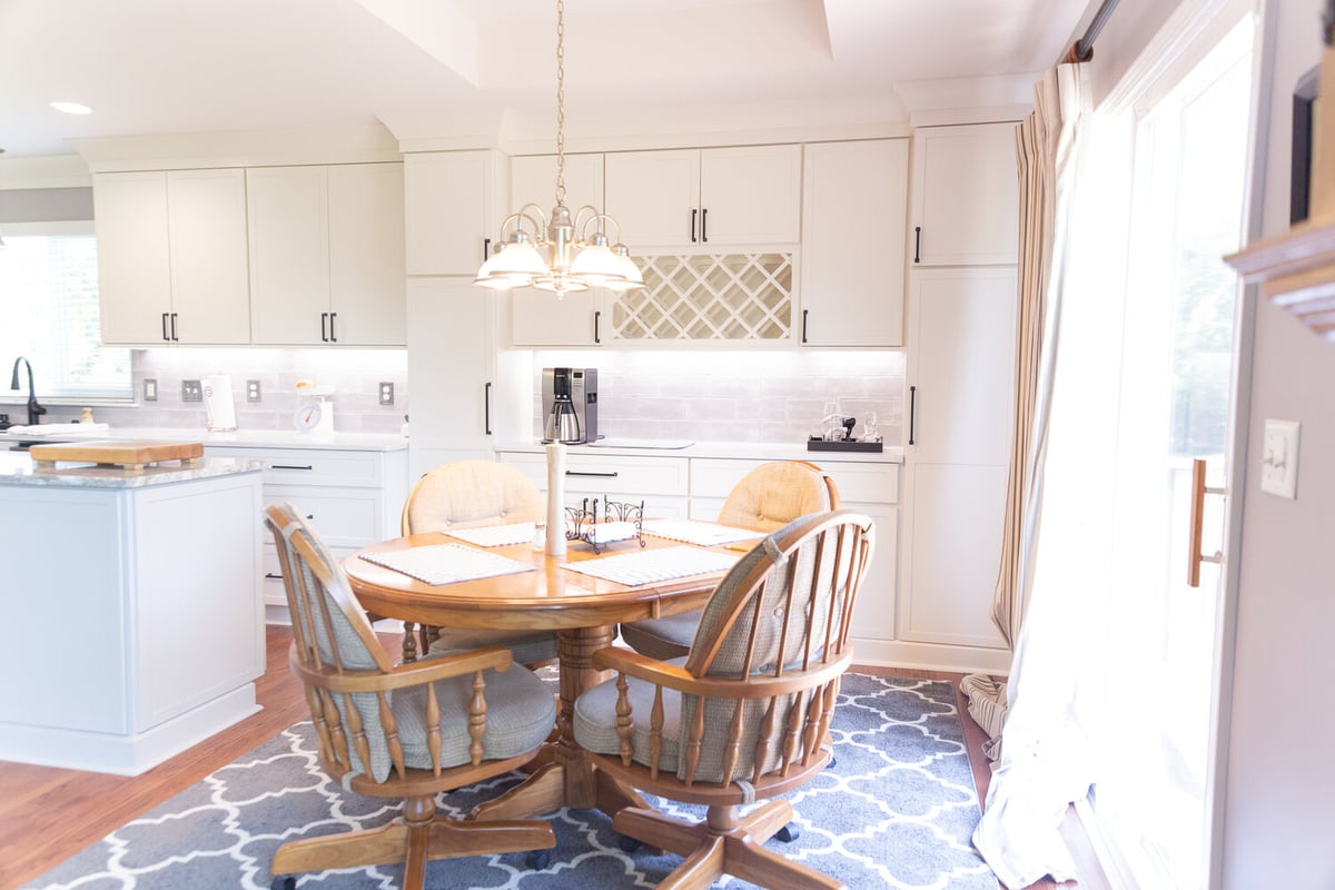 Open kitchen and dining area with white cabinetry by Cabinet Creations in Waterford Township, MI