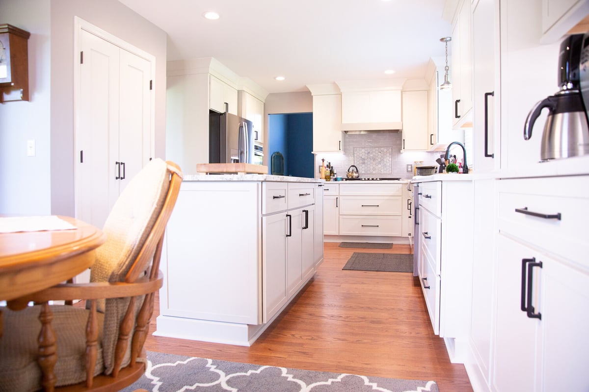 Open-concept kitchen remodel with shaker cabinets and wood floors by Cabinet Creations in Waterford Township, Michigan