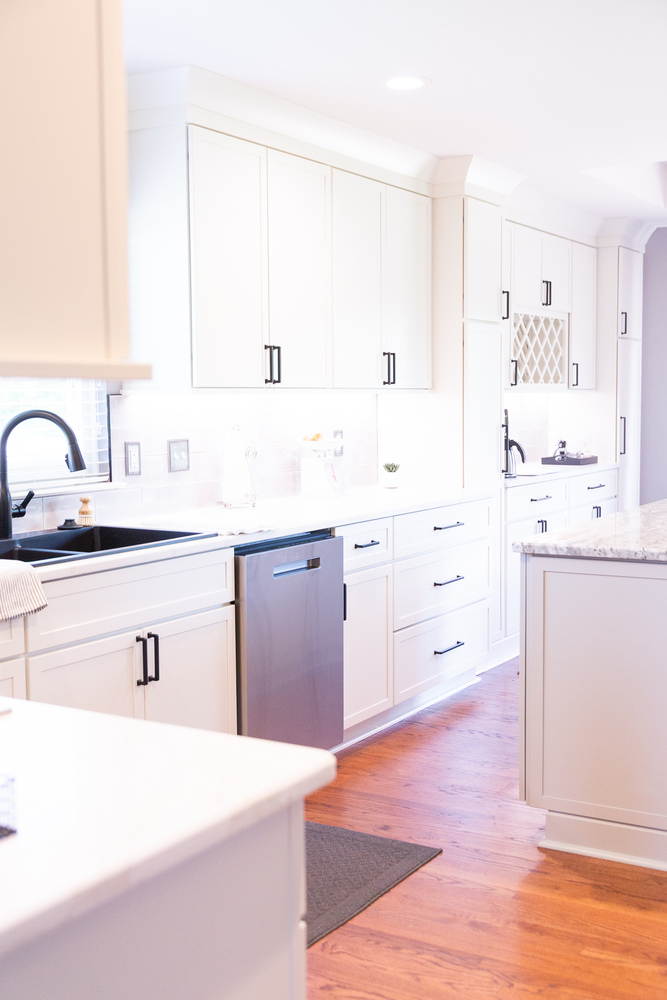 Spacious custom kitchen remodel with white shaker cabinets and dark hardware by Cabinet Creations in White Lake, Michigan