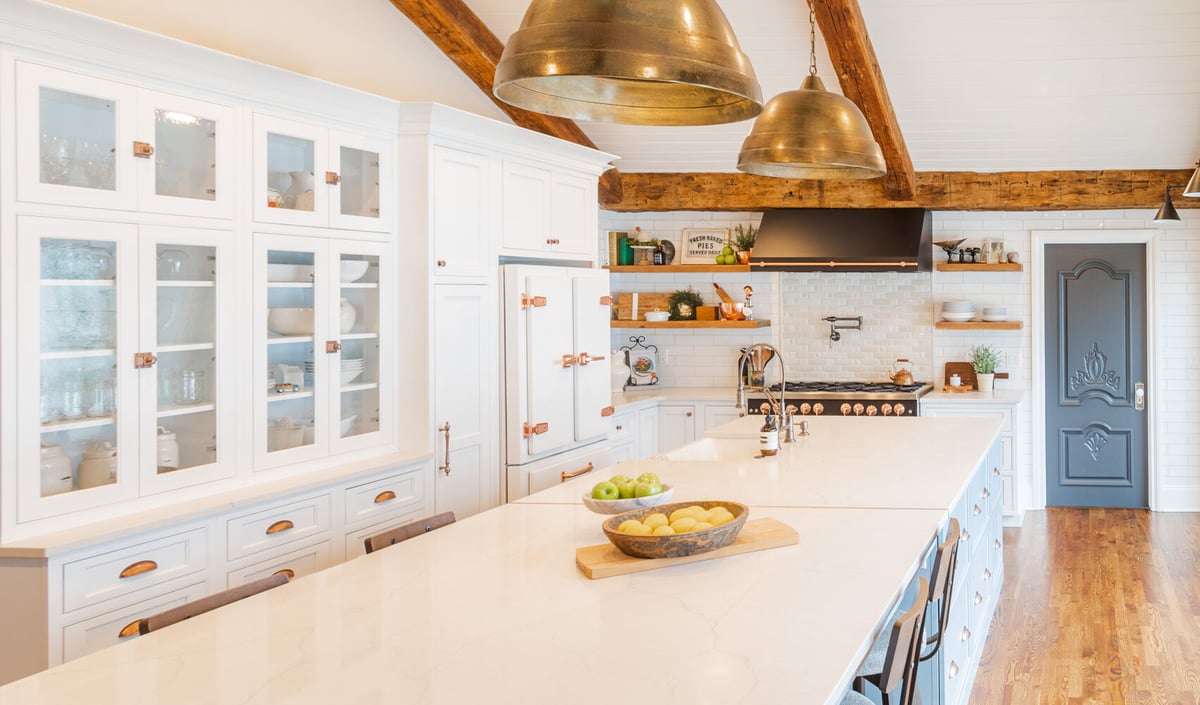 Custom kitchen remodel by Cabinet Creations in Oakland County, MI with exposed beams and brass pendant lighting