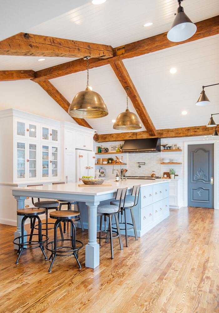 Full view of custom kitchen with rustic beams and island seating by Cabinet Creations in Oakland County, MI