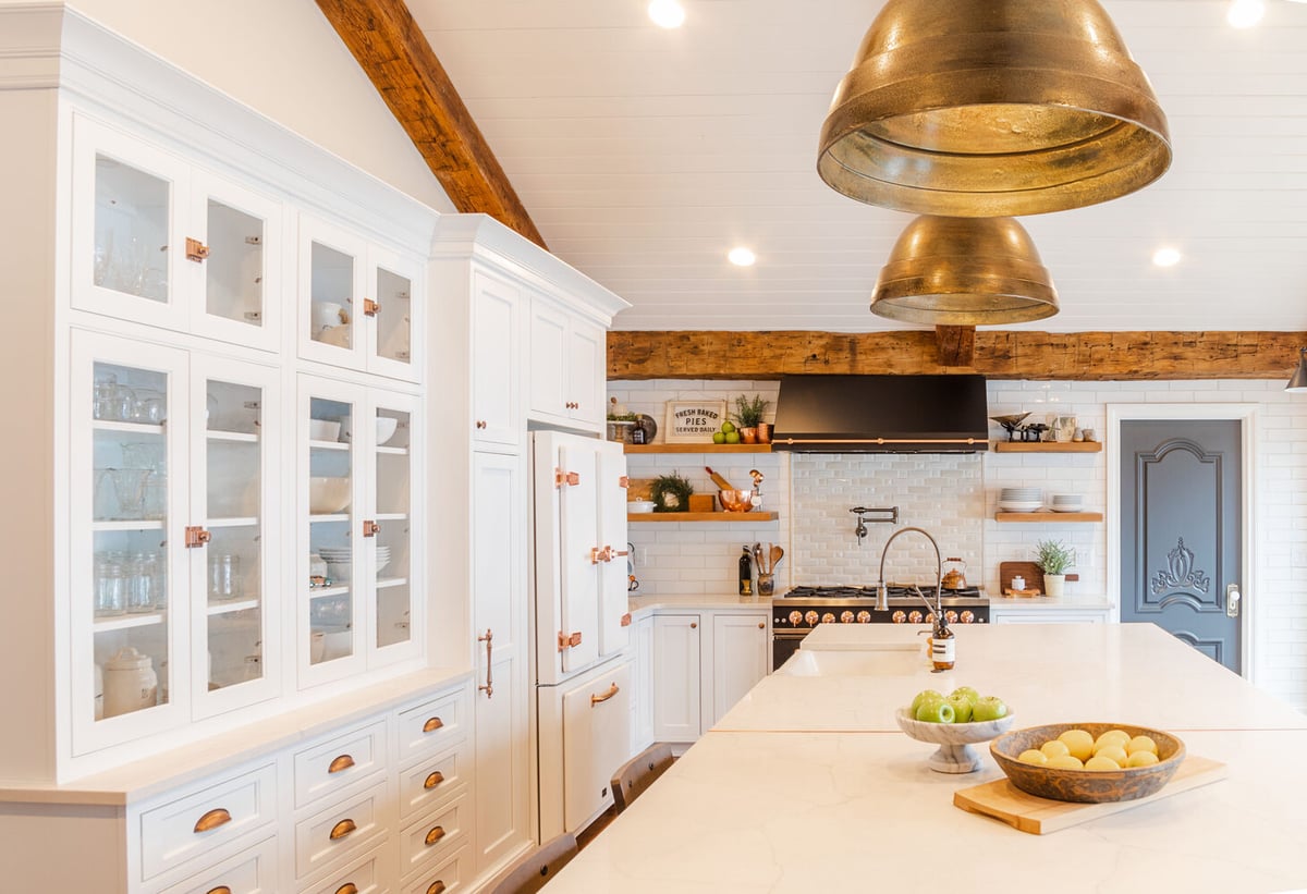 Glass-front cabinetry and modern lighting in a custom home kitchen by Cabinet Creations, Clarkston, MI