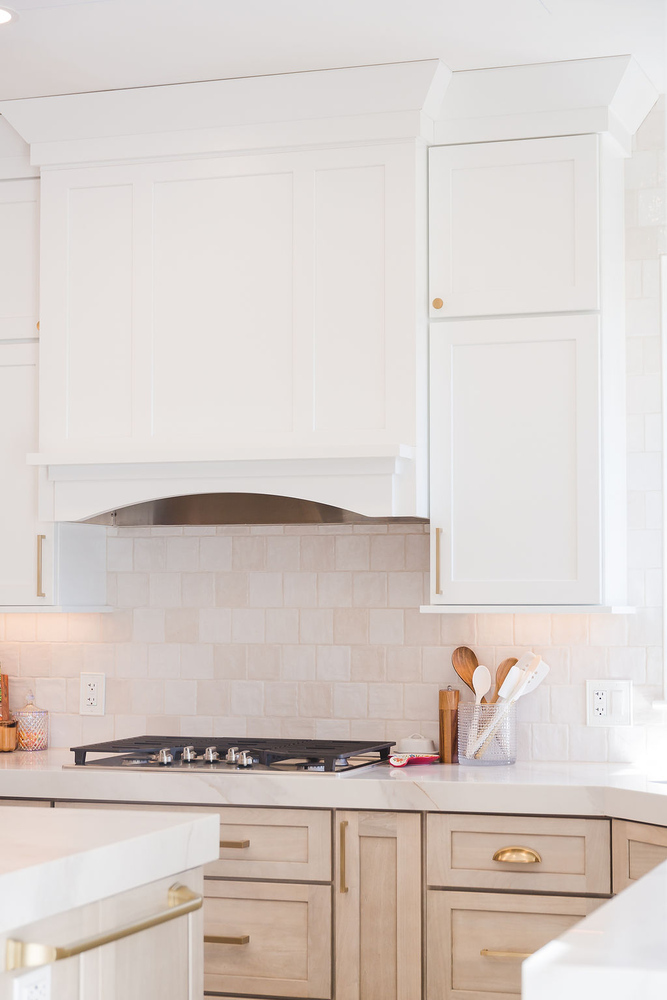 Bright custom kitchen design with gas cooktop and white tile backsplash in a Bloomfield Hills home