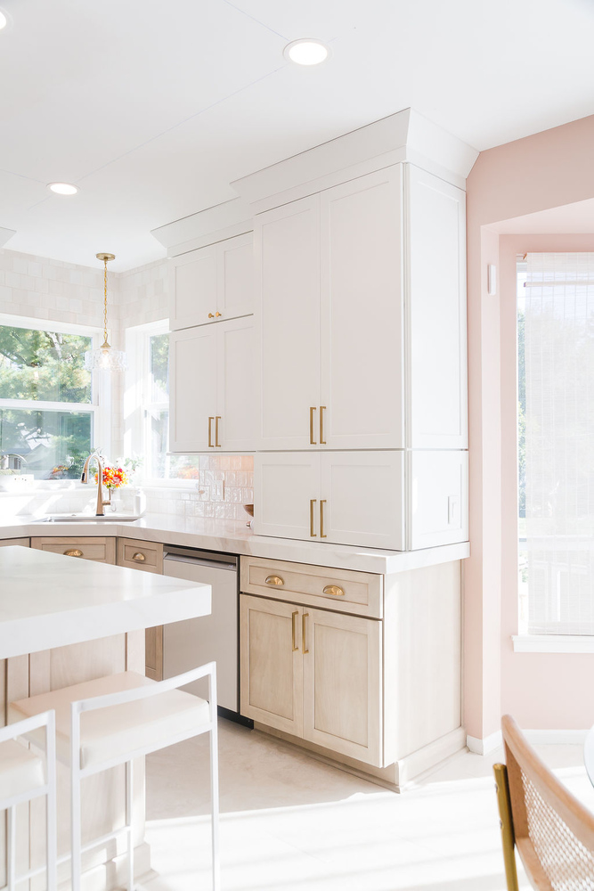 Bright kitchen corner with white cabinets and gold hardware by Cabinet Creations in Oakland County, MI
