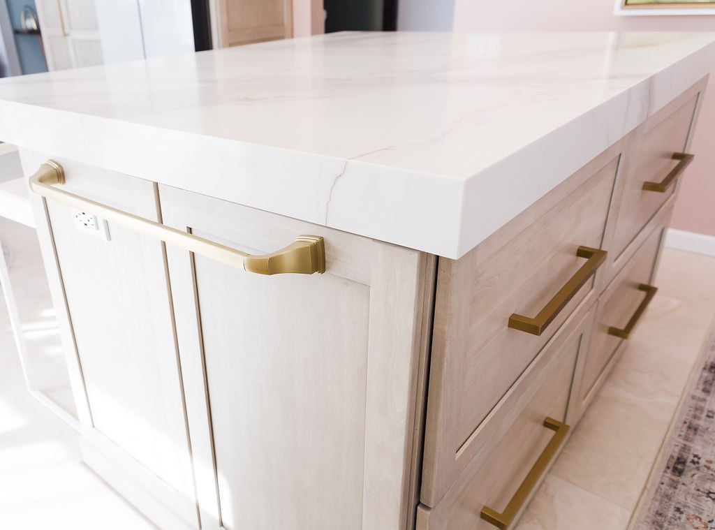 Custom kitchen island with gold hardware and quartz countertop by Cabinet Creations in Oakland County, MI