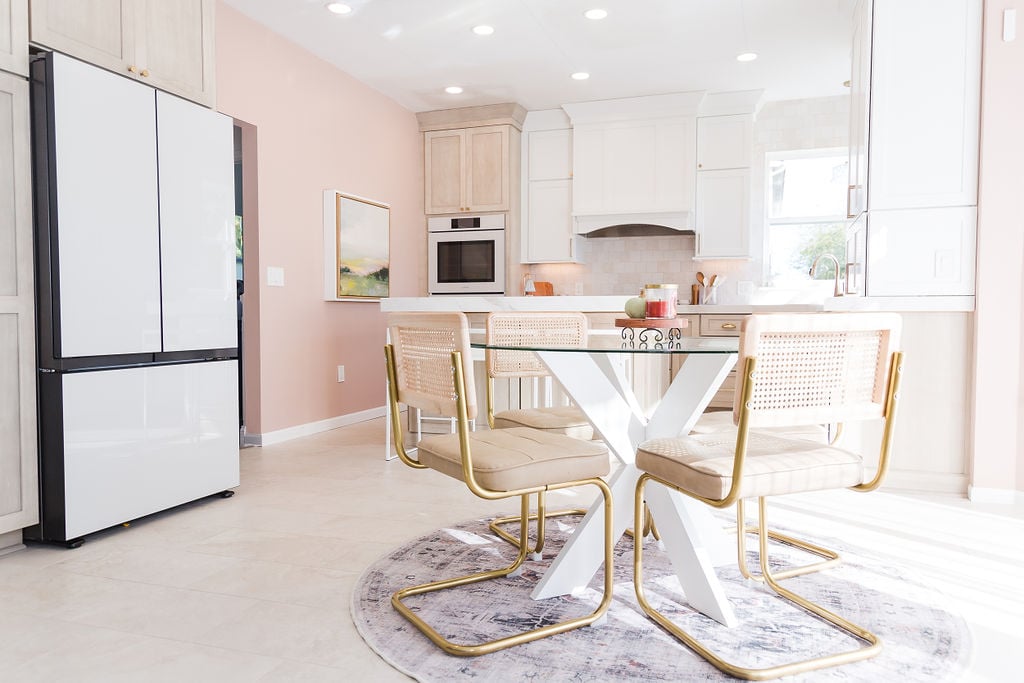 Custom kitchen with glass dining table and modern gold chairs by Cabinet Creations in Bloomfield Hills, MI