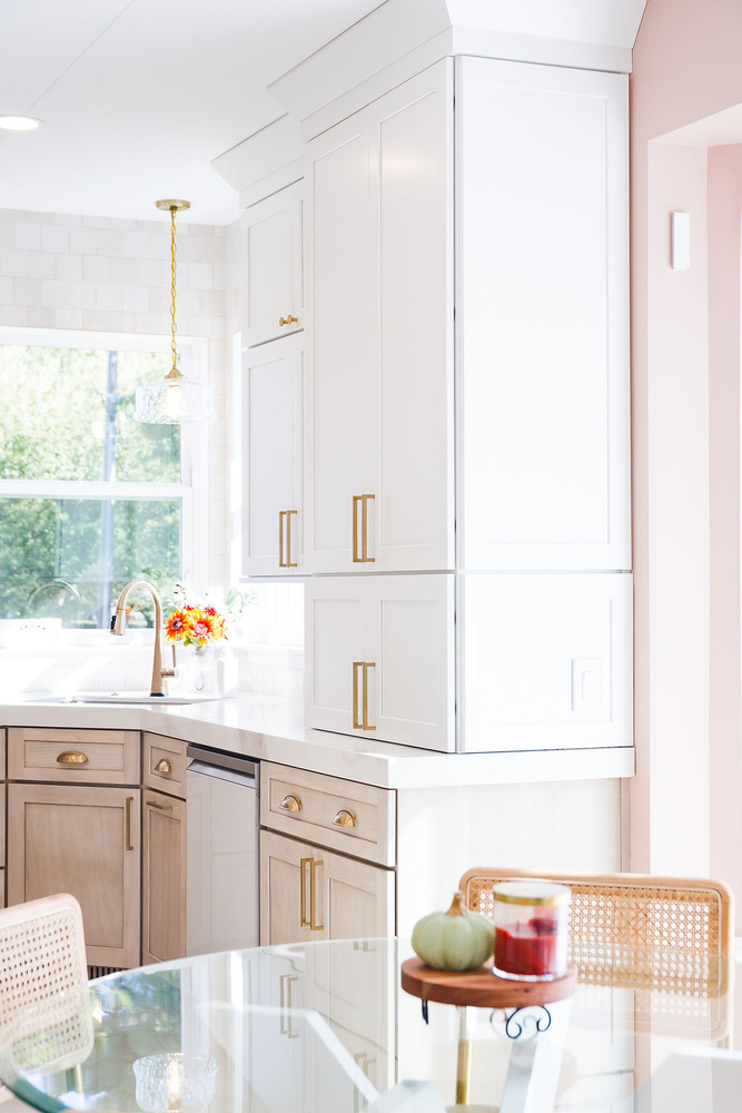 Elegant custom kitchen featuring tall white cabinets and gold handles by Cabinet Creations in Oakland County, Michigan
