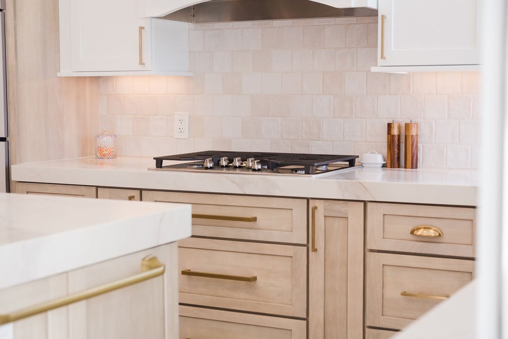 Elegant kitchen cooktop and backsplash design by Cabinet Creations in Bloomfield Hills, MI