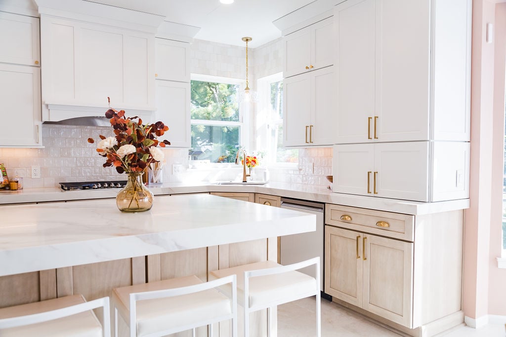Elegant modern kitchen with white countertops and gold hardware by Cabinet Creations in Waterford Township, MI