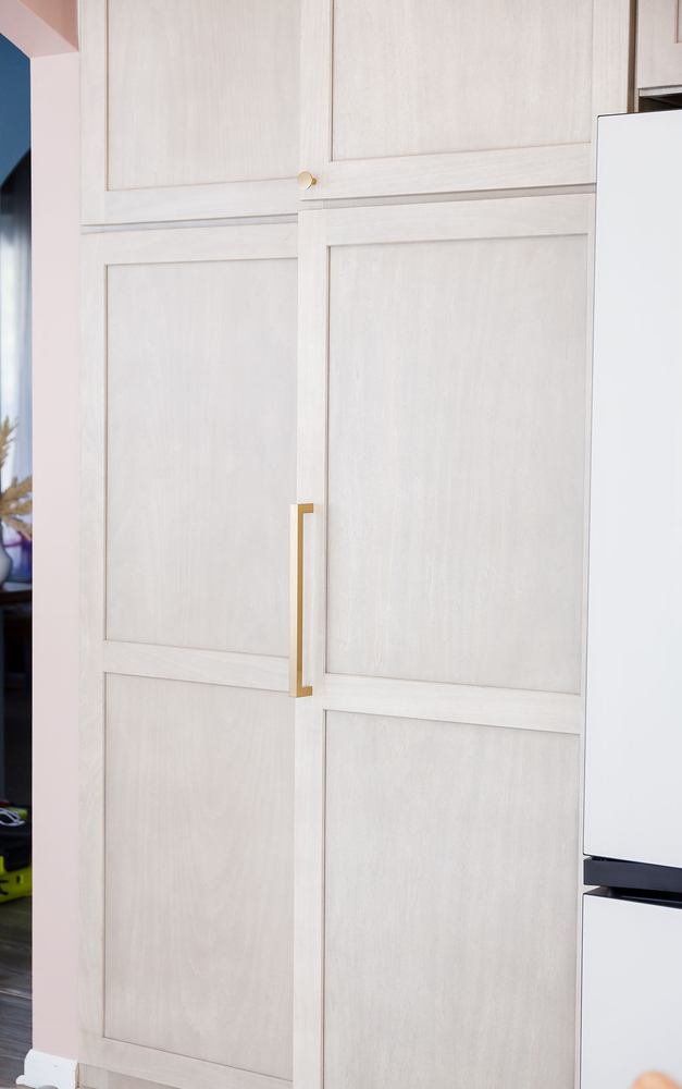 Elegant paneled kitchen cabinetry with brass handles in a custom home by Cabinet Creations in Oakland County, MI