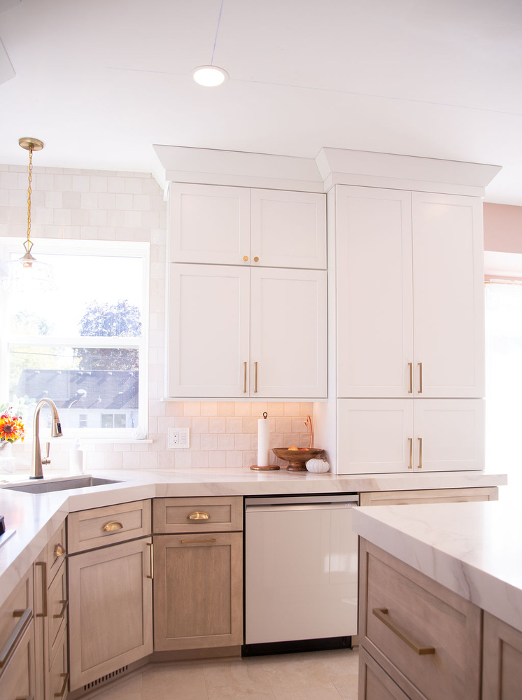 White cabinetry and marble counters in a modern custom kitchen by Cabinet Creations in Oakland County, MI