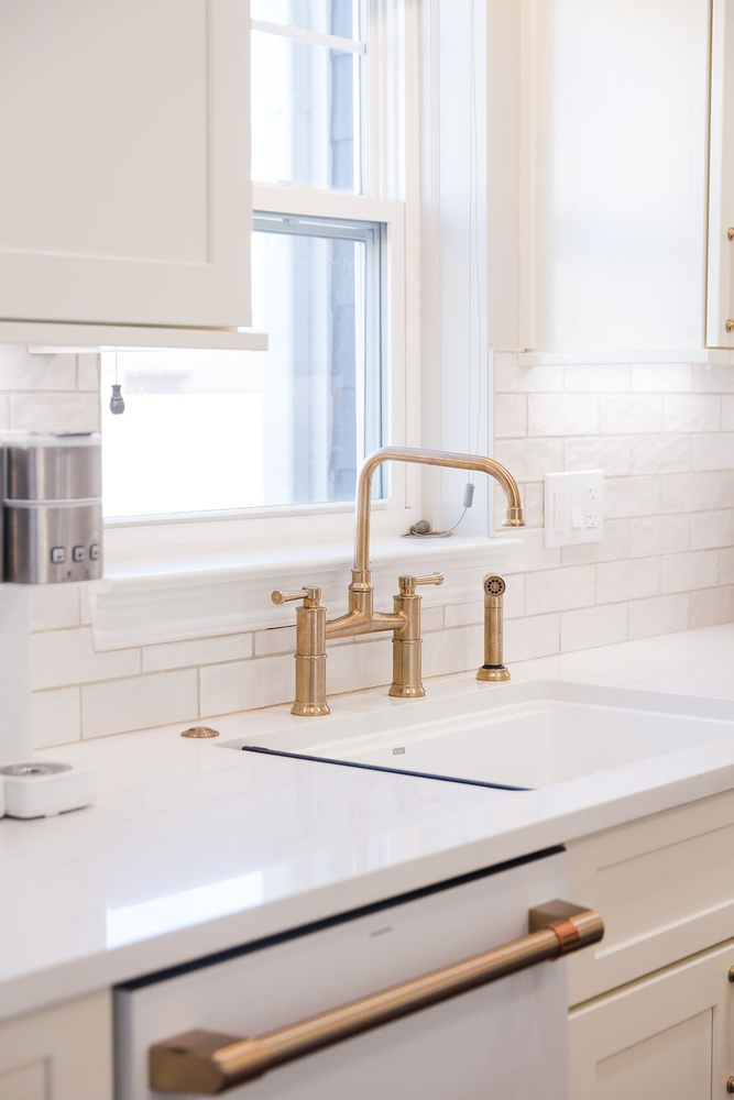 Brushed gold kitchen faucet and white sink installation by Cabinet Creations in Bloomfield Hills, MI