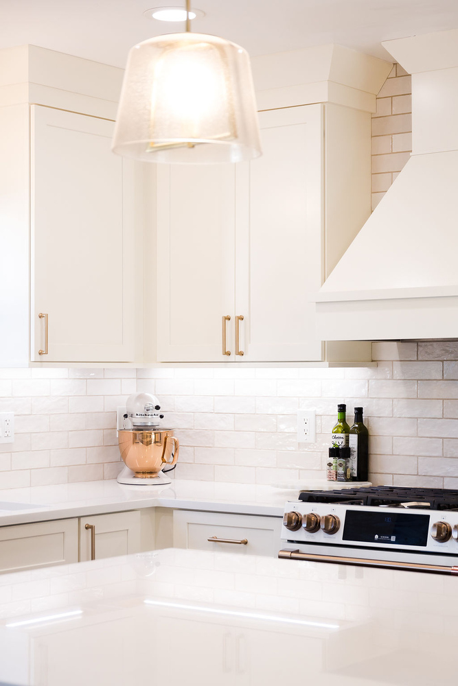 Modern white kitchen corner with quartz counters and custom cabinetry by Cabinet Creations in Michigan