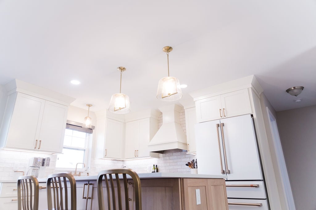 Wide view of custom Ferndale kitchen with pendant lights and wood island by Cabinet Creations