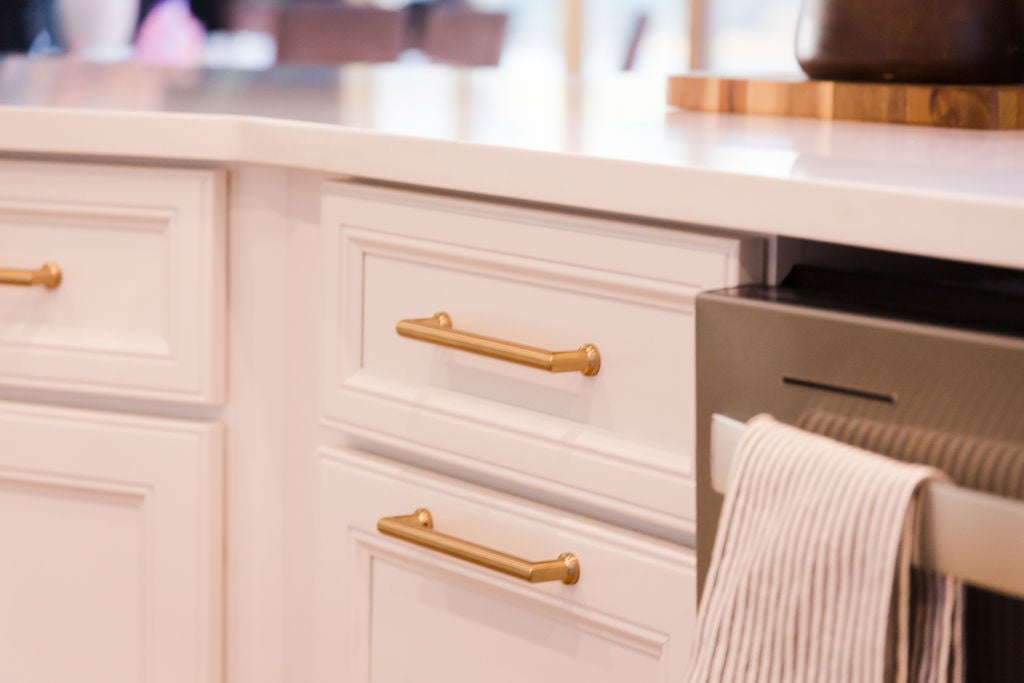 Close-up of gold cabinet drawer pulls in custom Michigan kitchen by Cabinet Creations
