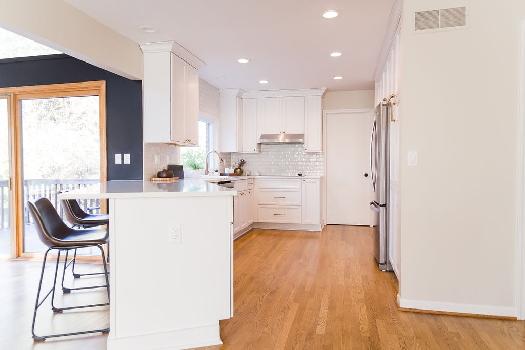 Spacious kitchen layout with white cabinetry and quartz countertops by Cabinet Creations in Ferndale, MI