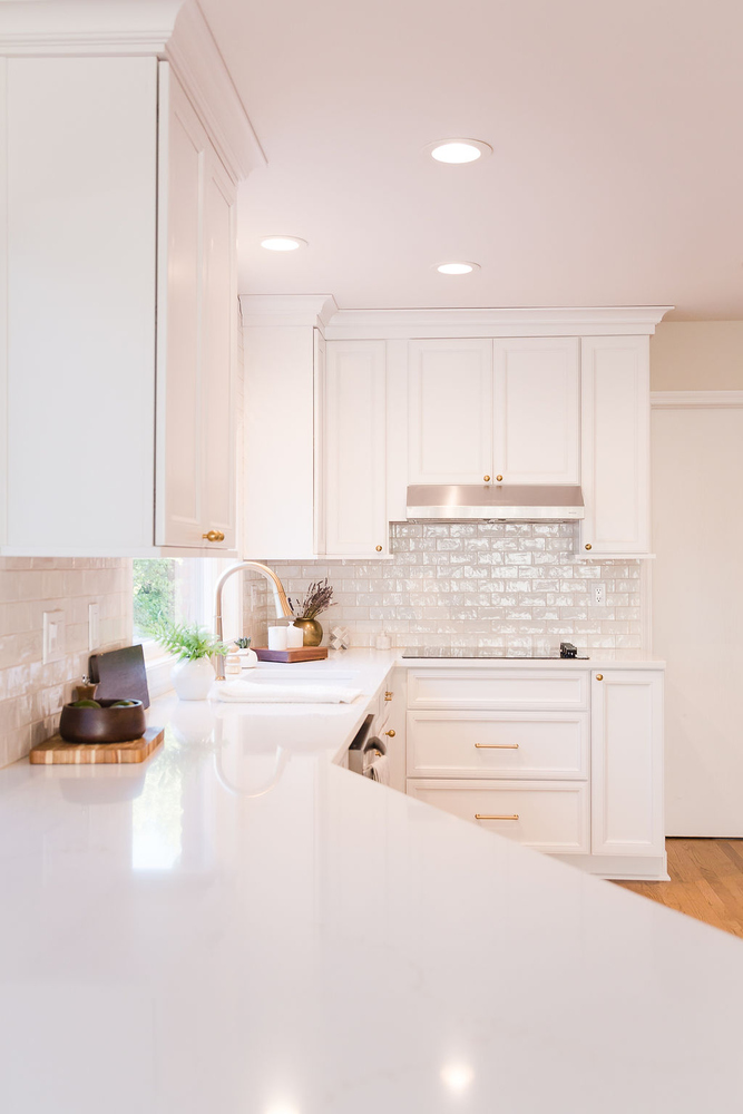 View of custom home kitchen in Waterford, MI with luxury finishes and under-cabinet lighting by Cabinet Creations