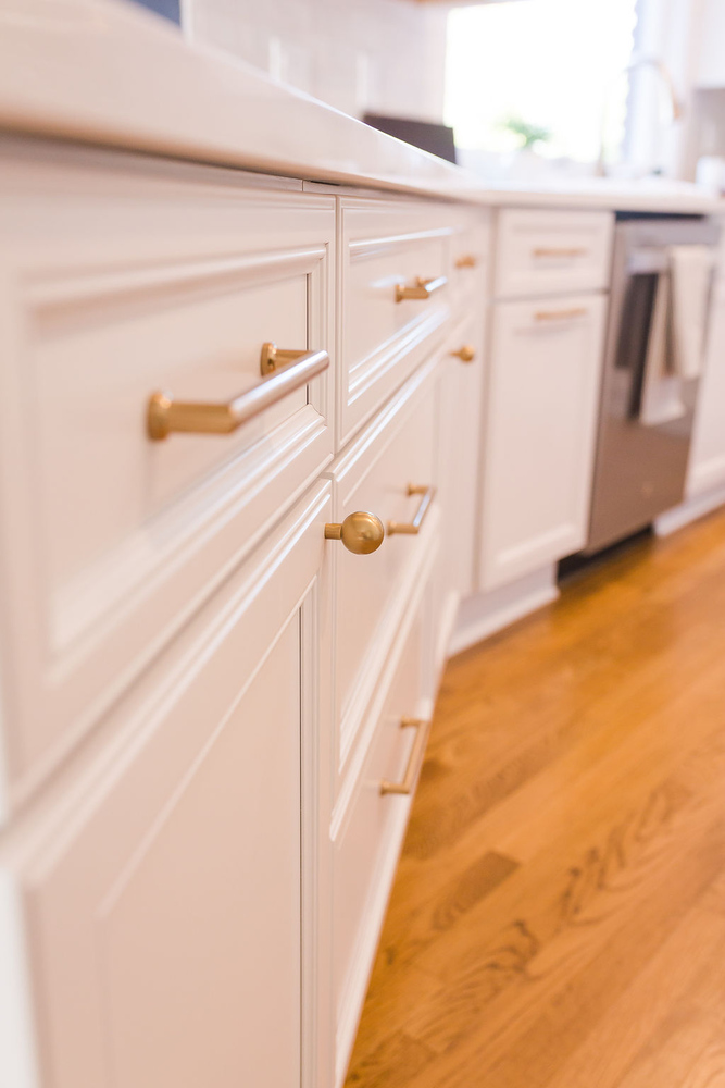 White drawers with gold hardware in custom kitchen remodel by Cabinet Creations, Oakland County, MI